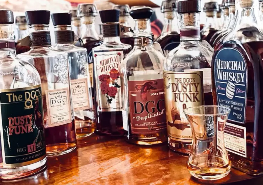 A lineup of DGC private barrel selections and Medicinal Whiskey Charity bottlings on a tasting table
